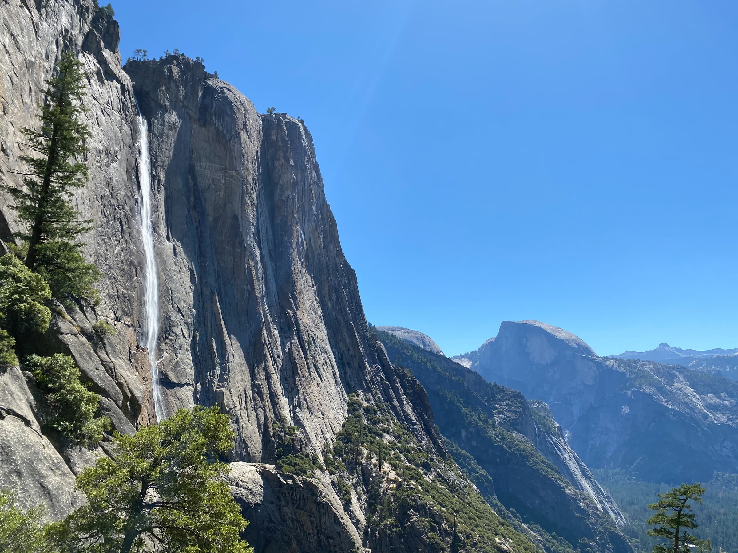 A tall mountain with a waterfall running down its side